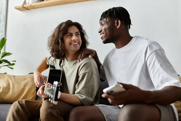 Two partners enjoy a joyful moment at home, making memories while playing music. — Stock Photo