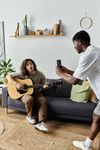 Una coppia si gode un pomeriggio musicale, condividendo risate e amore mentre uno suona la chitarra splendidamente. — Foto stock