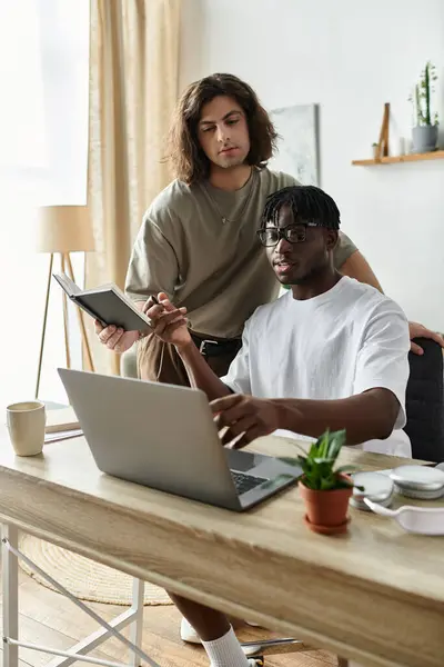 Two partners engage in a meaningful discussion at their cozy home workspace, smiling and connecting. — Stock Photo
