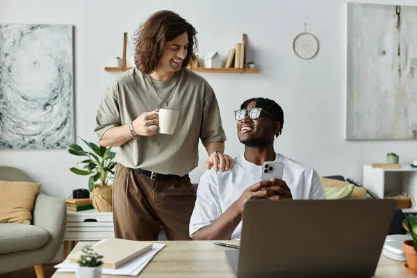 Two partners smile and laugh together in their cozy living space. — Stock Photo