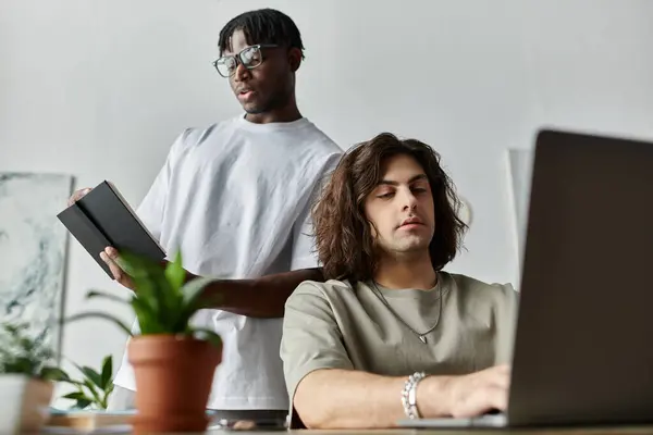 A loving couple collaborates at home, engaging in conversation while one types on a laptop. — Stock Photo