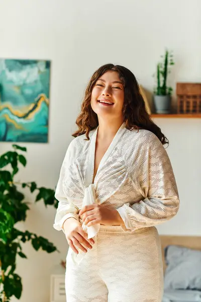 A plus size woman radiates happiness while standing in her cozy living space at home. — Stock Photo