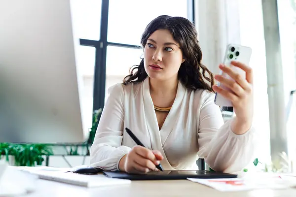 La donna plus size si concentra intensamente sul suo lavoro in ufficio mentre tiene il suo smartphone. — Foto stock