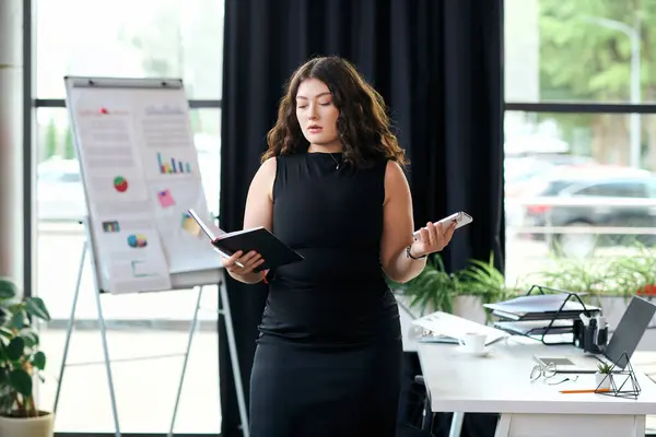 A young businesswoman with long curly hair presents data in an inviting corporate office, showcasing her expertise. — Stock Photo