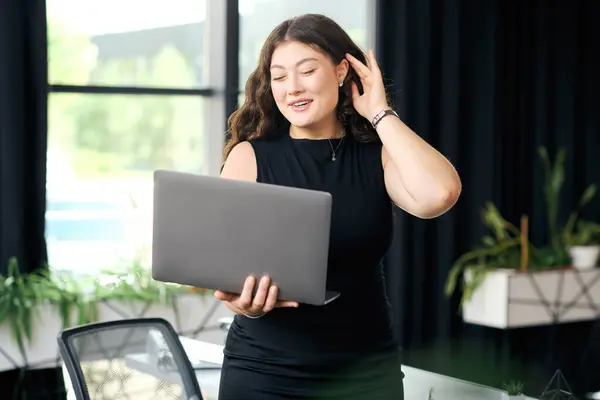 Une jeune femme confiante aux longs cheveux bouclés participe activement à une réunion d'affaires à son bureau. — Photo de stock