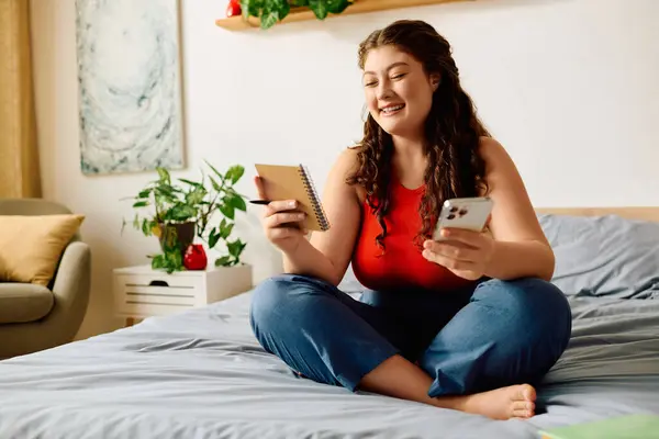 Веселая женщина plus size с кудрявыми волосами занимается творчеством дома, в окружении бурной атмосферы. — стоковое фото