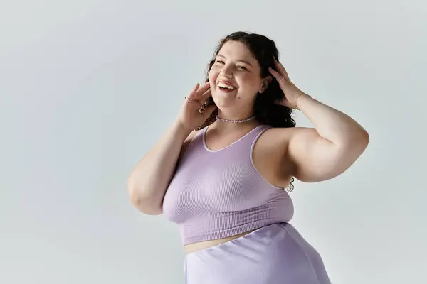 An elegant plus size woman playfully poses, showcasing her confidence while smiling brightly. — Stock Photo