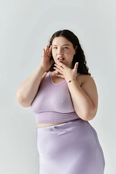 A confident plus size woman radiates beauty in stylish lavender, embracing self love. — Stock Photo