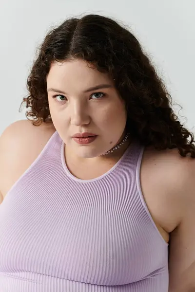A beautiful plus size woman poses gracefully, showcasing her style and self assurance indoors. — Stock Photo