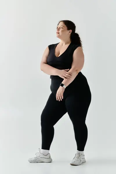 A graceful full figure woman stands tall, showcasing her unique style and confidence. — Stock Photo