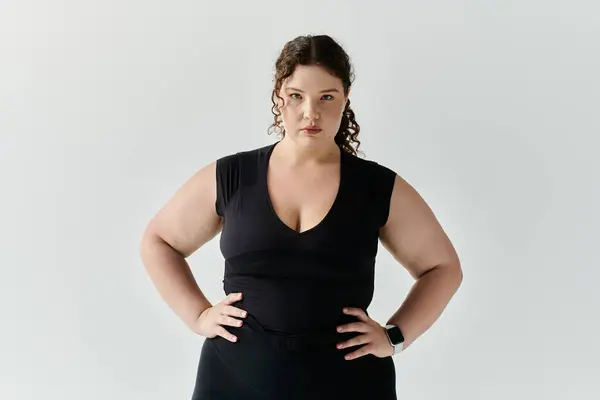 A graceful plus size woman stands with poise, showcasing her confidence and fashion sense. — Stock Photo