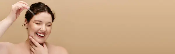A joyful plus size woman gently applies skincare, radiating confidence and beauty. — Stock Photo