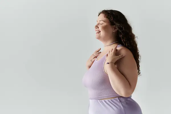 An elegant plus size woman embraces her beauty with joy and confidence, showcasing self love. — Stock Photo