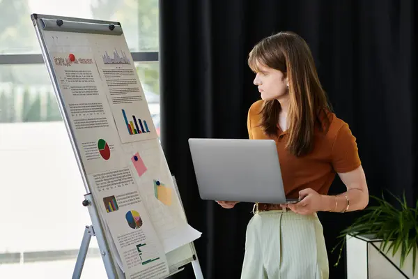 The young non binary person captivates the audience with research on their laptop. — Stock Photo