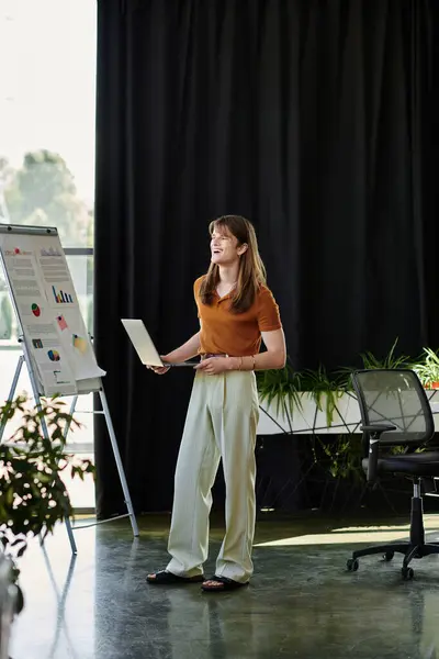 In a stylish office, a young non binary individual energetically presents data charts to colleagues. — Stock Photo
