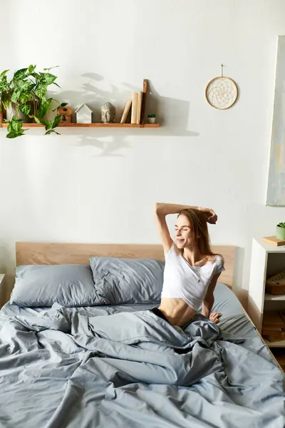 A young woman relaxes in bed, surrounded by a tranquil home environment, reflecting her journey with anorexia. — Stock Photo