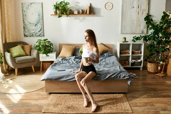 In a serene room, a young woman with anorexia embraces happiness while relaxing at home, savoring her personal space and comfort. — Stock Photo