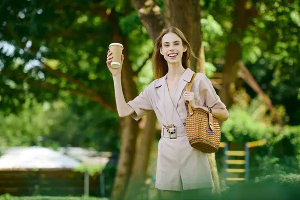 A young woman with anorexia revels in nature, holding a coffee cup while joyfully soaking up the sun warmth. — Stock Photo