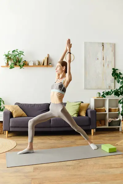 A dedicated woman with anorexia performs yoga in her living room, emphasizing fitness and mindfulness as part of her daily self-care. — Stock Photo
