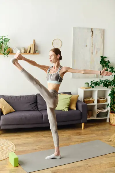 A young woman with anorexia engages in a focused workout session at home, highlighting her daily commitment to fitness and wellness. — Stock Photo
