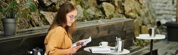 In a cozy cafe, a young woman wreads menu, sipping her coffee and enjoying her day. — Stock Photo