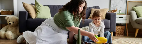 A mother and her young daughter enjoy a moment of creativity with toys on the floor together. — Stock Photo