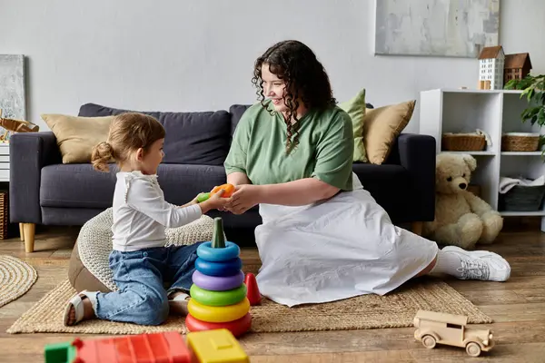 A mother and her daughter enjoy quality time together, engaging in playful activities at home. — Stock Photo