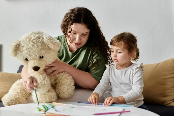 A joyful moment spent together as a mother and daughter color and enjoy each others company. — Stock Photo