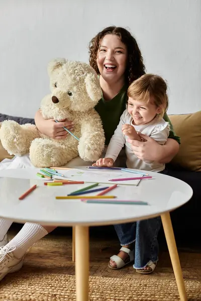 The loving bond between a mother and daughter shines as they draw together, laughing joyfully. — Stock Photo