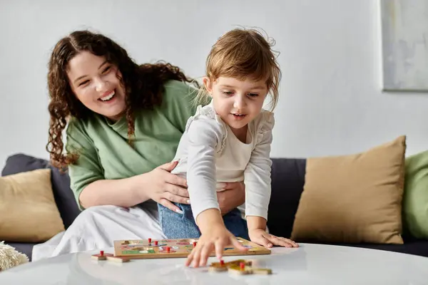 A beautiful plus size woman joyfully engages with her daughter, enjoying a playful moment together. — Stock Photo