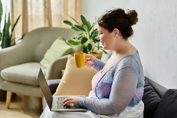Positivo más mujer de tamaño en traje casual disfruta de un día relajado en casa. - foto de stock