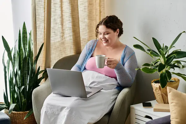 Merry woman holding her laptop while at home. — Stock Photo