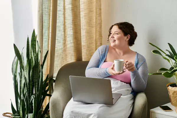 Jolly woman holding her laptop while at home. — Stock Photo