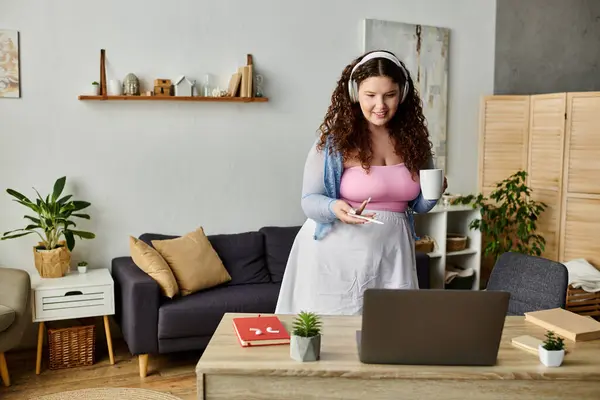 Joyous woman with curly hair and comfy vibrant attire at home. — Stock Photo