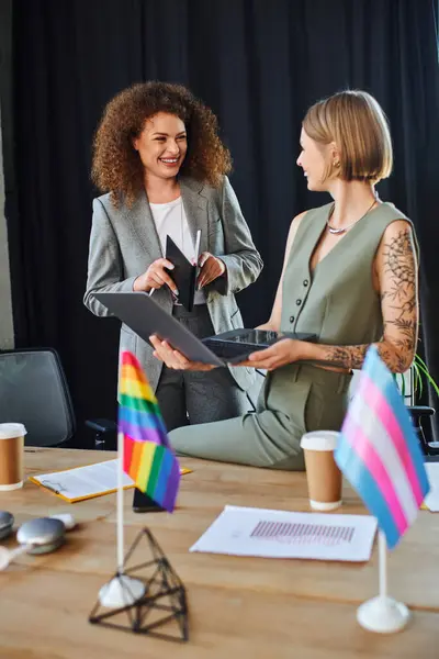 Two coworkers share a joyful moment while celebrating diversity and inclusion at work. — Stock Photo