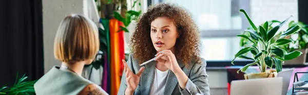 Two coworkers passionately discuss ideas and inclusivity in their lively office environment. — Stock Photo