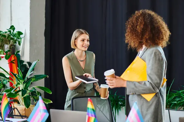 Coworkers engage in a lively discussion, showcasing their support for the LGBTQ community. — Stock Photo