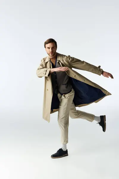 A dapper individual elegantly showcases his ensemble while playfully posing in a trendy outfit. — Stock Photo