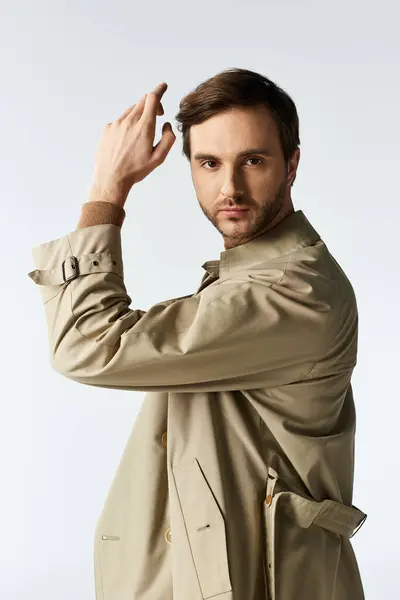 A fashionable man confidently showcases his attire, striking a pose that captures attention. — Stock Photo