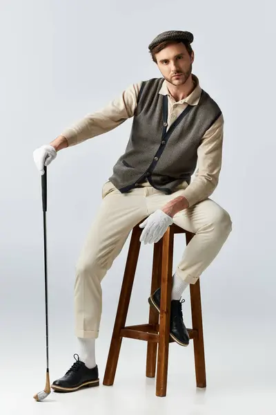 A stylish figure leans on a stool, radiating charm and sophistication. — Stock Photo