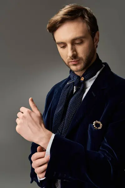 A handsome man dressed in a sophisticated outfit meticulously adjusts his cufflinks with finesse. — Stock Photo