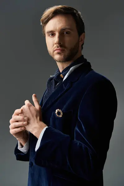 A sophisticated figure exudes charm while adjusting his cuffs against a minimalist backdrop. — Stock Photo