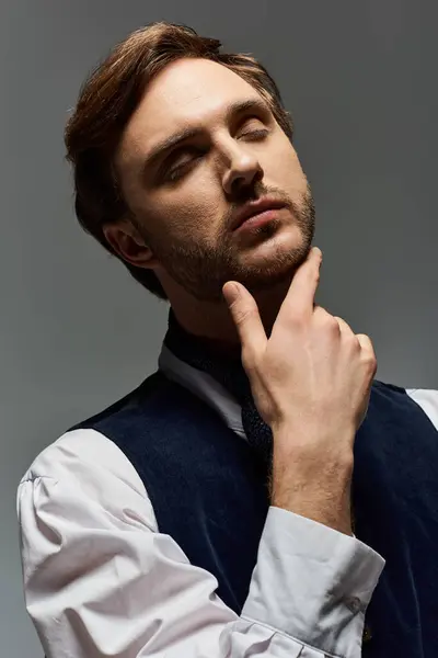 A handsome man stands confidently, lost in contemplation, showcasing a dapper ensemble. — Stock Photo