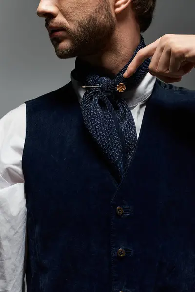 A dandy elegantly styles his outfit while preparing for a classy evening event indoors. — Stock Photo