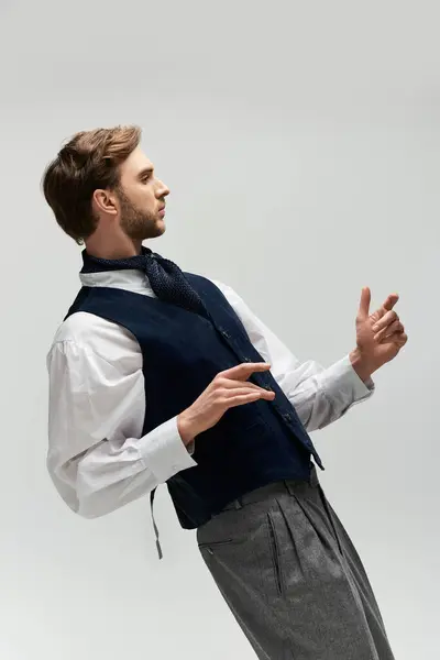 A stylish figure in a tailored outfit poses elegantly against a simple backdrop. — Stock Photo