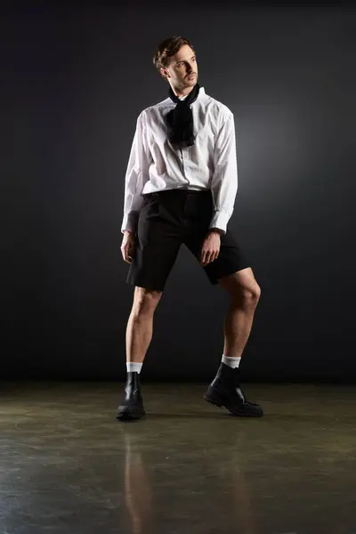 A fashionable individual exhibits charisma in a black and white ensemble with a modern twist. — Stock Photo