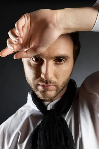 A handsome individual showcases a fashionable style with an intriguing pose and expression. — Stock Photo