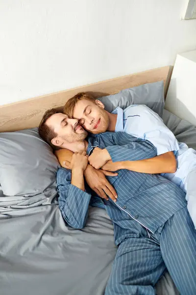 A loving gay couple enjoys a cozy morning together in their pajamas, sharing warmth and happiness. — Stock Photo