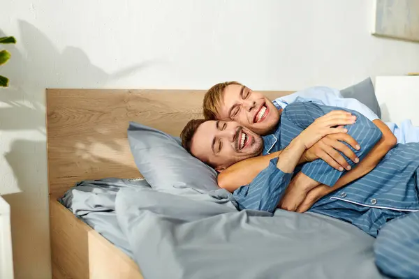 Two men share a warm, affectionate moment in pajamas, enjoying each others company on a leisurely morning. — Stock Photo