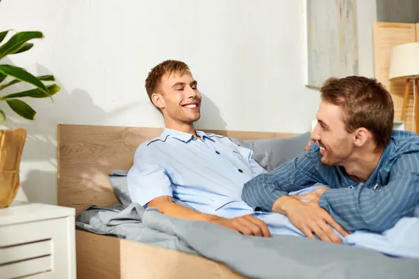 A couple shares laughter and warmth in their cozy pajamas, enjoying a peaceful morning together. — Stock Photo